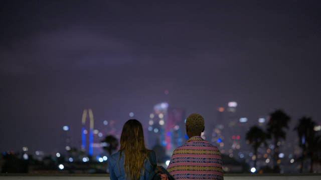 Kate and Helena look at the LA skyline at night