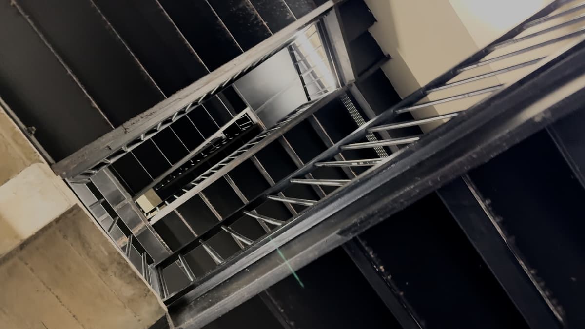 A view looking upward through a winding staircase.